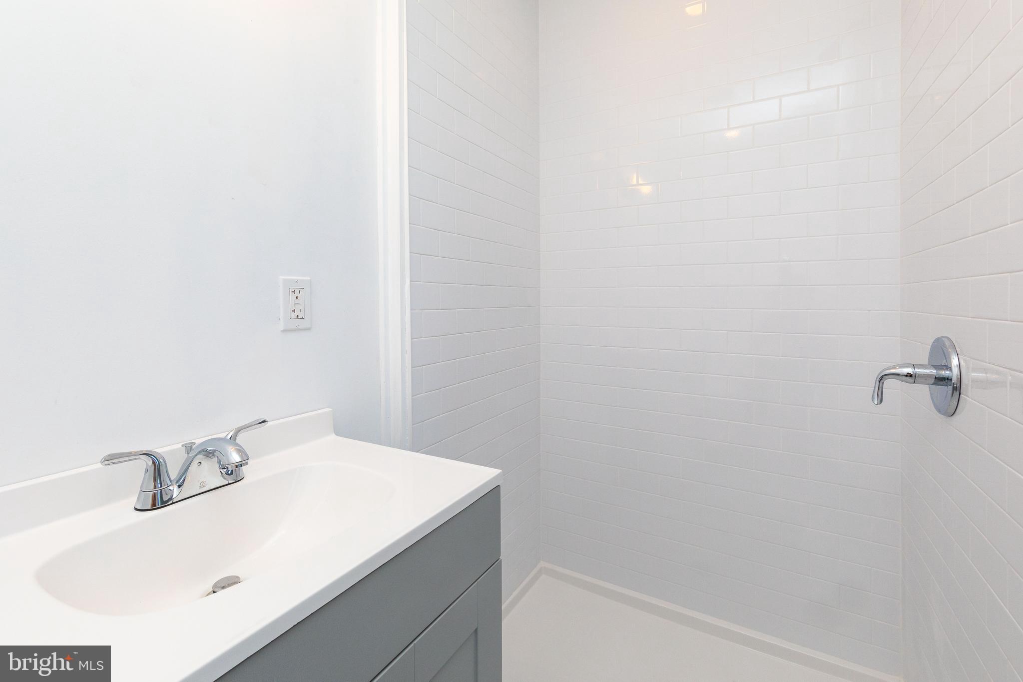1841 North 33rd Street Philadelphia, PA 19121 - Photo 9 of 29 a bathroom with a sink and a vanity