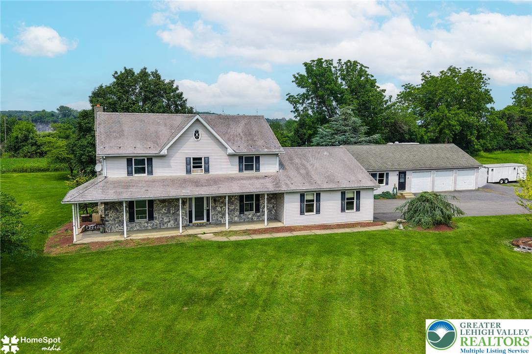 829 Georgetown Road Nazareth, PA 18064 - Photo 1 of 54 An expansive lawn frames this classic country home featuring a wide front porch and matching siding.