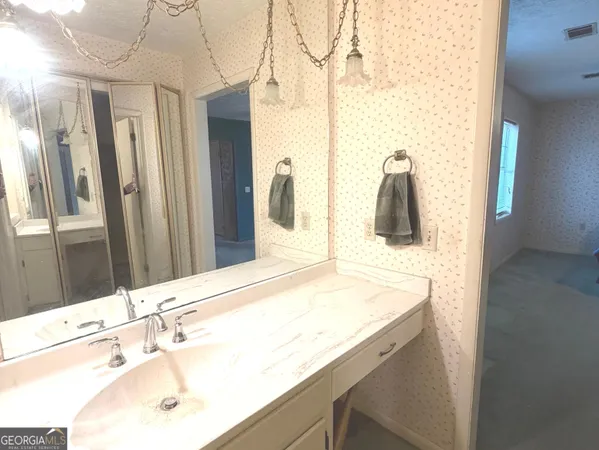a bathroom with a sink and a mirror