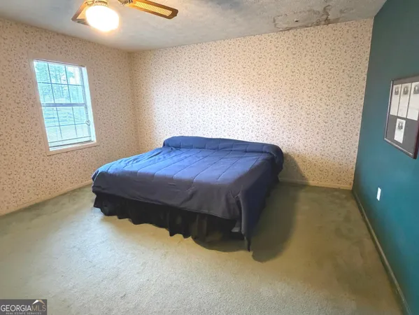 a bedroom with a bed and window