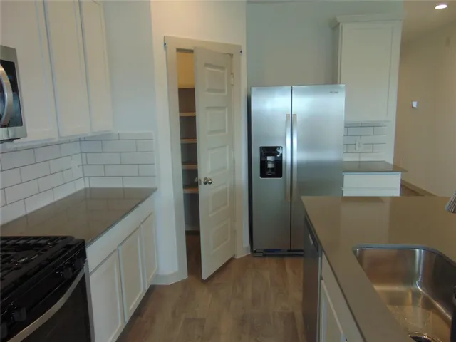 a kitchen with a sink and refrigerator