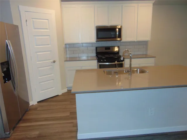 a view of kitchen with microwave and cabinets