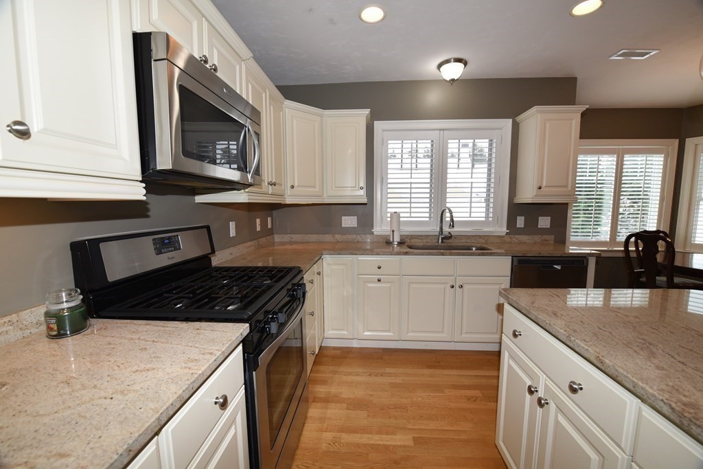 2 Mariner's Drive, Unit 2 (AKA 66) Marshfield, MA 02050 - Photo 15 of 41 a kitchen with granite countertop a sink a stove and cabinets