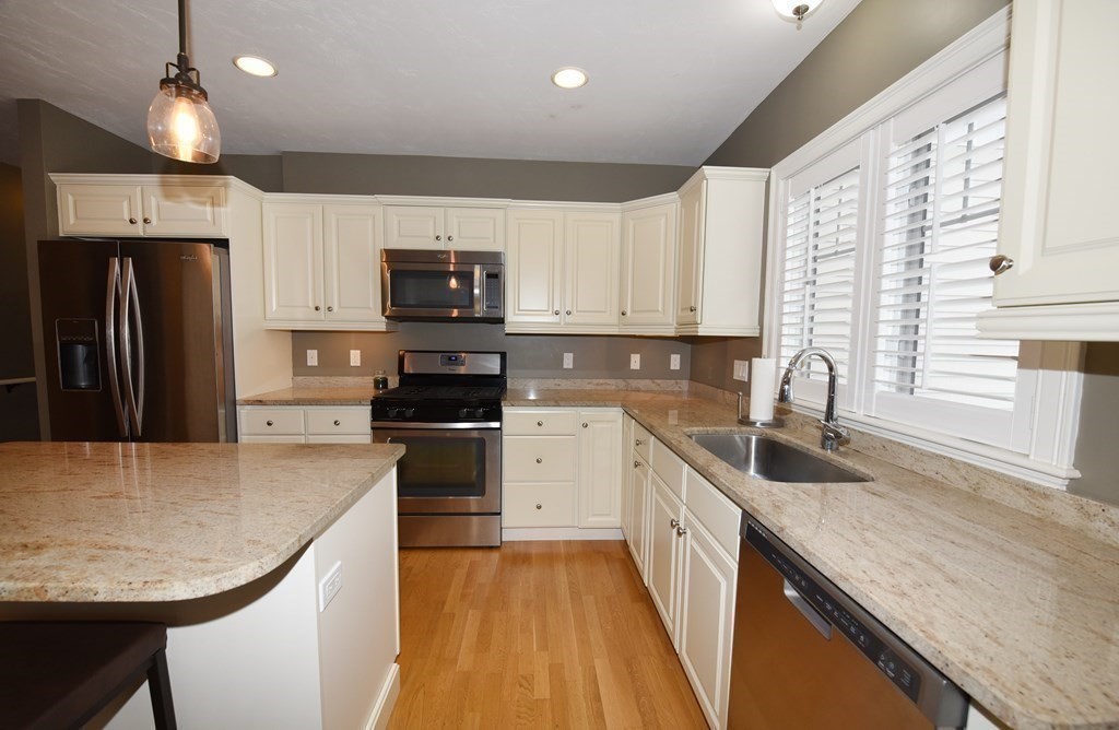 2 Mariner's Drive, Unit 2 (AKA 66) Marshfield, MA 02050 - Photo 16 of 41 a kitchen with stainless steel appliances granite countertop a sink stove and refrigerator