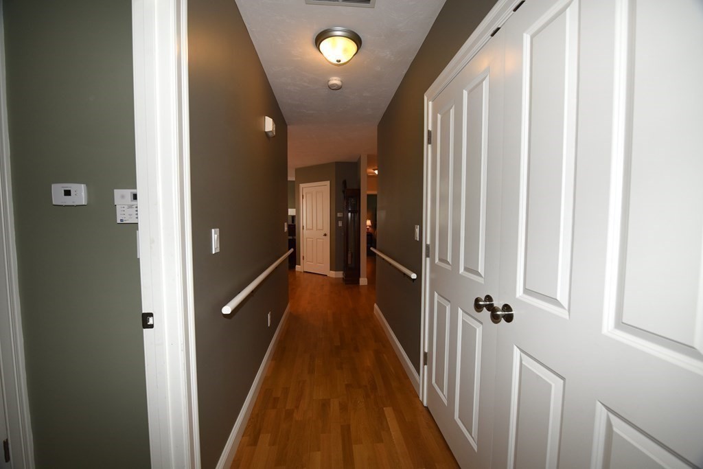 2 Mariner's Drive, Unit 2 (AKA 66) Marshfield, MA 02050 - Photo 20 of 41 a view of a hallway with a yellow carpet