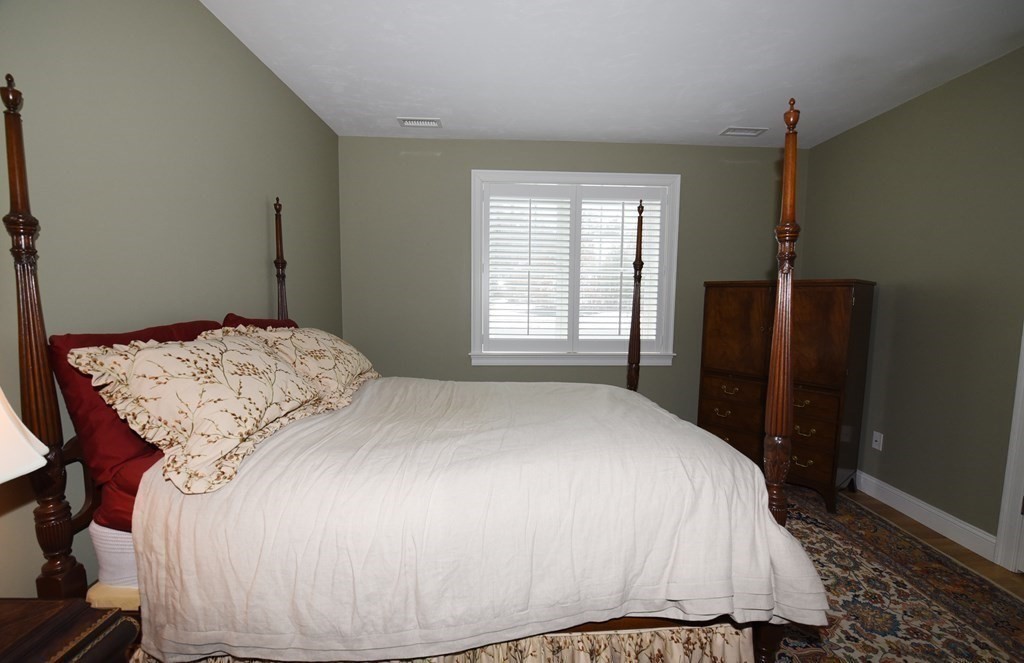 2 Mariner's Drive, Unit 2 (AKA 66) Marshfield, MA 02050 - Photo 28 of 41 a bedroom with a bed and wooden floor