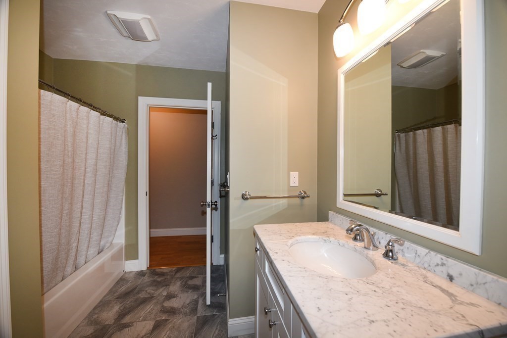 2 Mariner's Drive, Unit 2 (AKA 66) Marshfield, MA 02050 - Photo 31 of 41 a bathroom with a granite countertop sink and a mirror