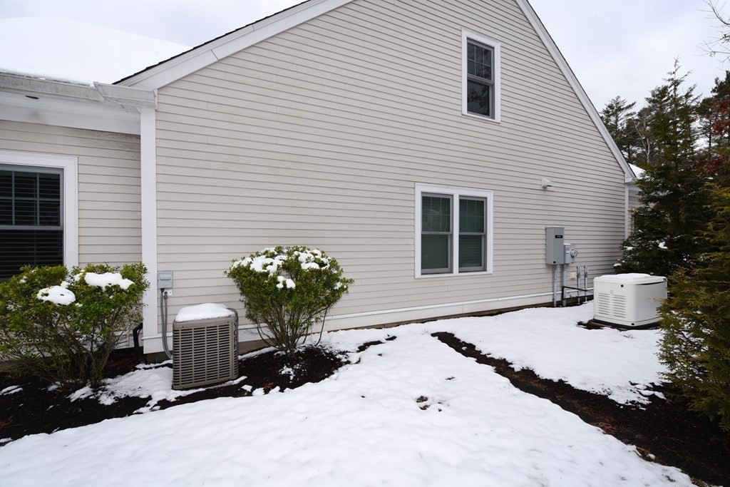 2 Mariner's Drive, Unit 2 (AKA 66) Marshfield, MA 02050 - Photo 9 of 41 a front view of a house with a yard