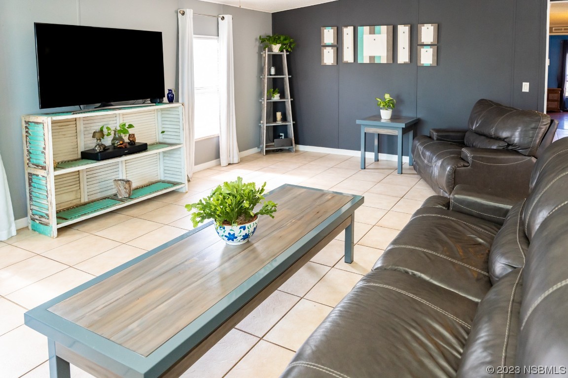 106 Charles Street Edgewater, FL 32141 - Photo 11 of 89 a living room with furniture and a flat screen tv