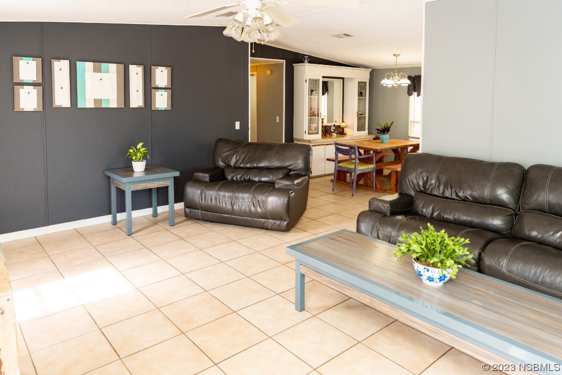 106 Charles Street Edgewater, FL 32141 - Photo 13 of 89 a living room with furniture flowerpot and wooden floor