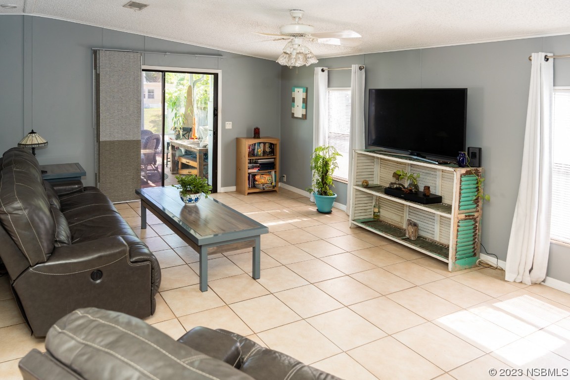 106 Charles Street Edgewater, FL 32141 - Photo 14 of 89 a living room with furniture and a flat screen tv