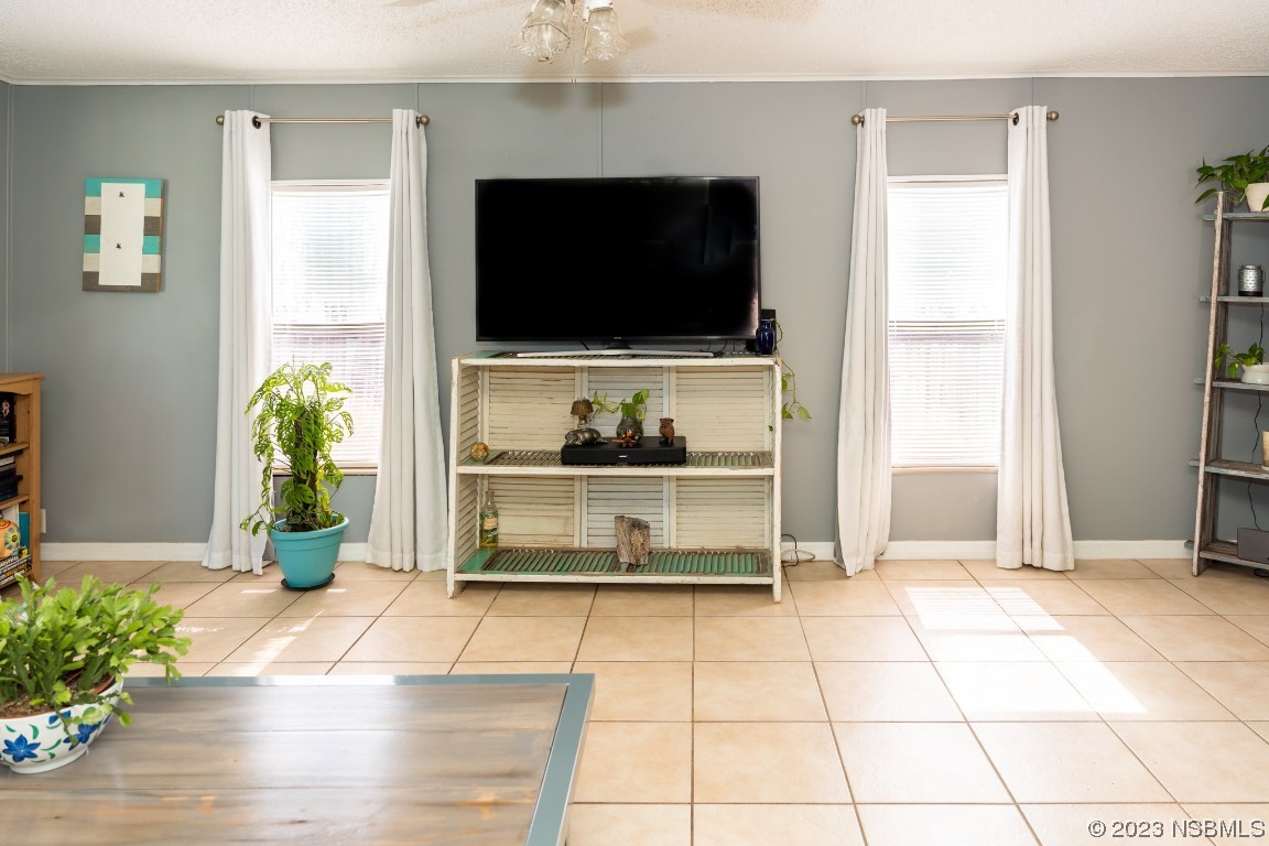 106 Charles Street Edgewater, FL 32141 - Photo 16 of 89 a living room with fish tank and a flat screen tv