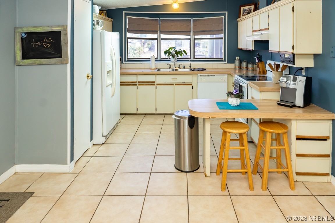 106 Charles Street Edgewater, FL 32141 - Photo 17 of 89 a kitchen with a sink a stove and cabinets