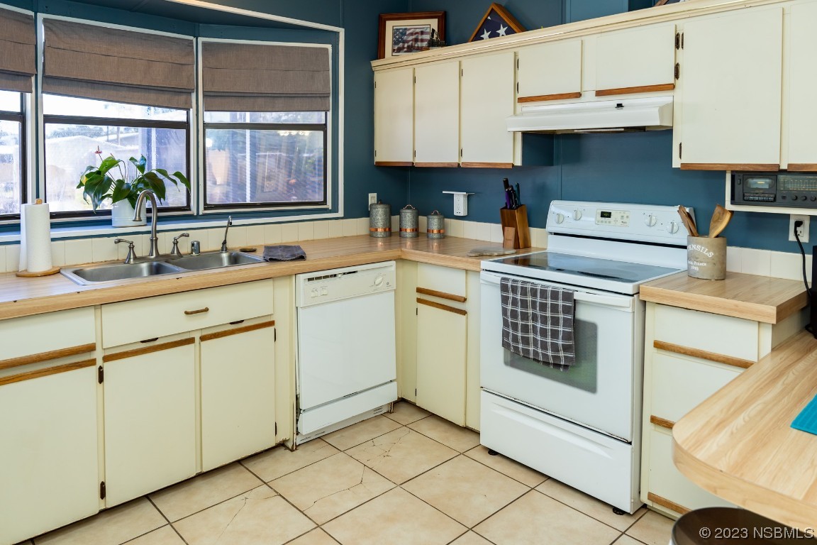 106 Charles Street Edgewater, FL 32141 - Photo 18 of 89 a kitchen with cabinets appliances a sink and a window