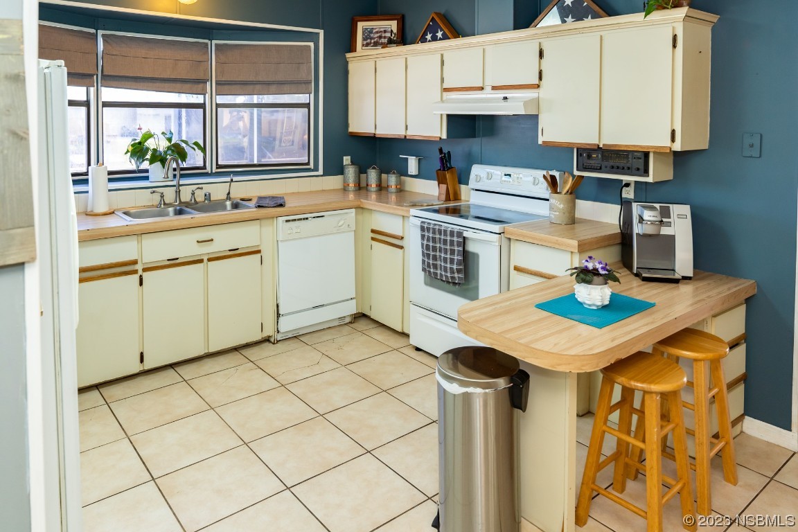 106 Charles Street Edgewater, FL 32141 - Photo 19 of 89 a kitchen with a sink cabinets and window
