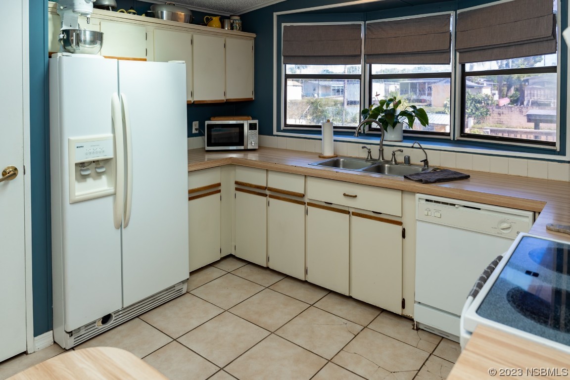 106 Charles Street Edgewater, FL 32141 - Photo 20 of 89 a kitchen with stainless steel appliances a refrigerator sink and cabinets