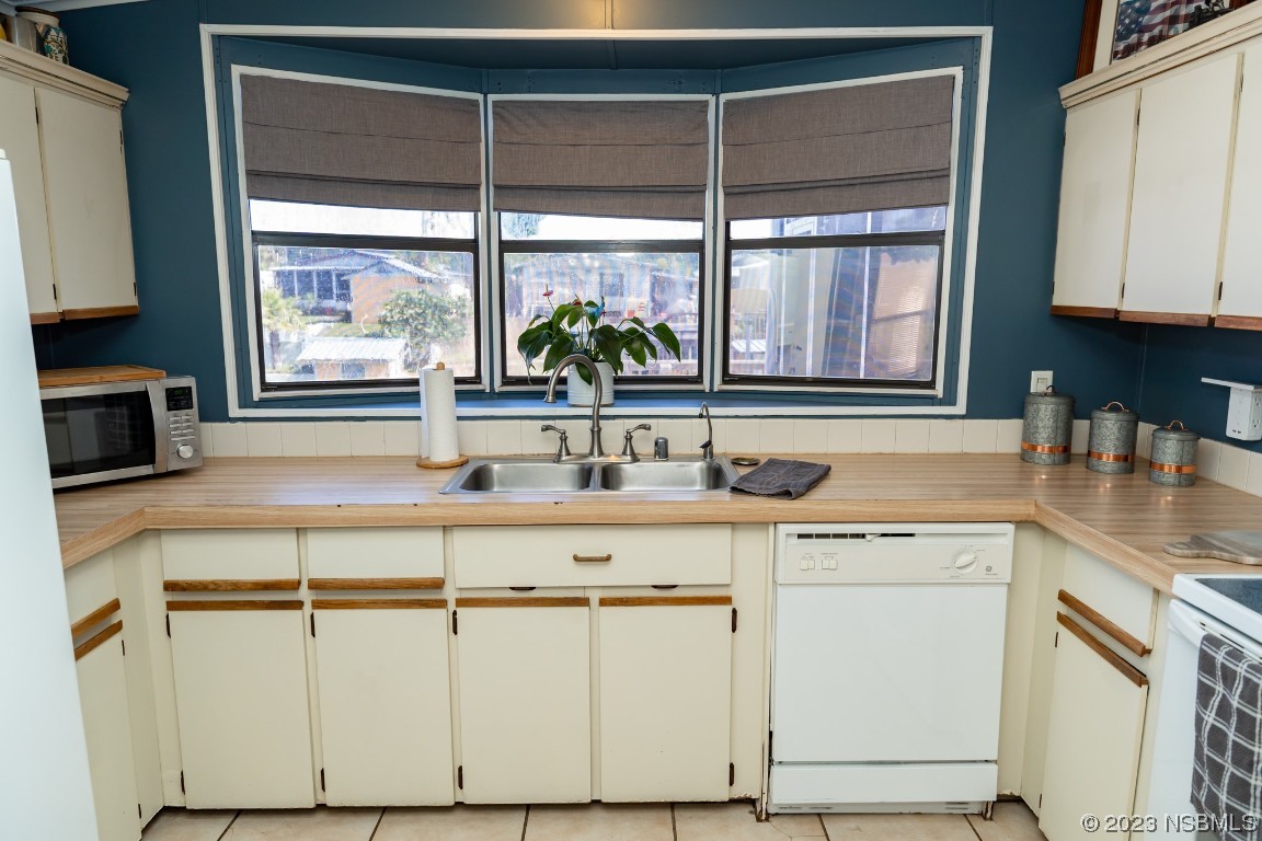 106 Charles Street Edgewater, FL 32141 - Photo 23 of 89 a kitchen with a sink cabinets and window