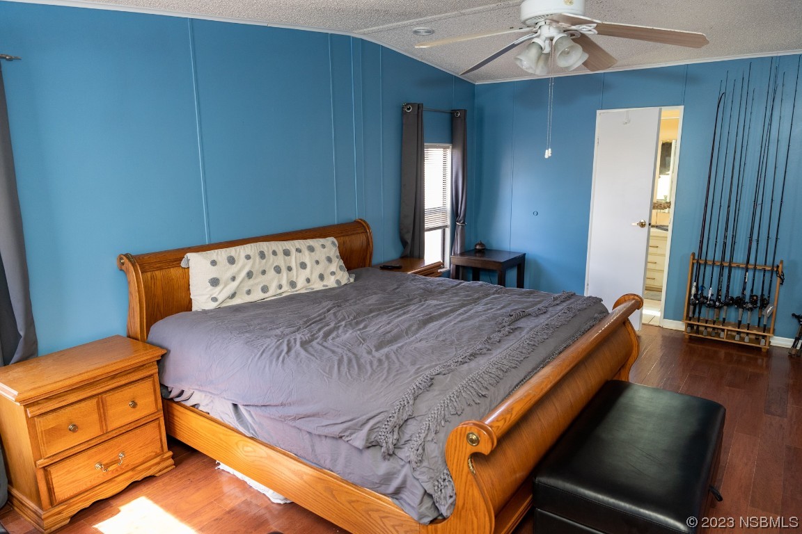 106 Charles Street Edgewater, FL 32141 - Photo 32 of 89 a bedroom with a bed and a chandelier