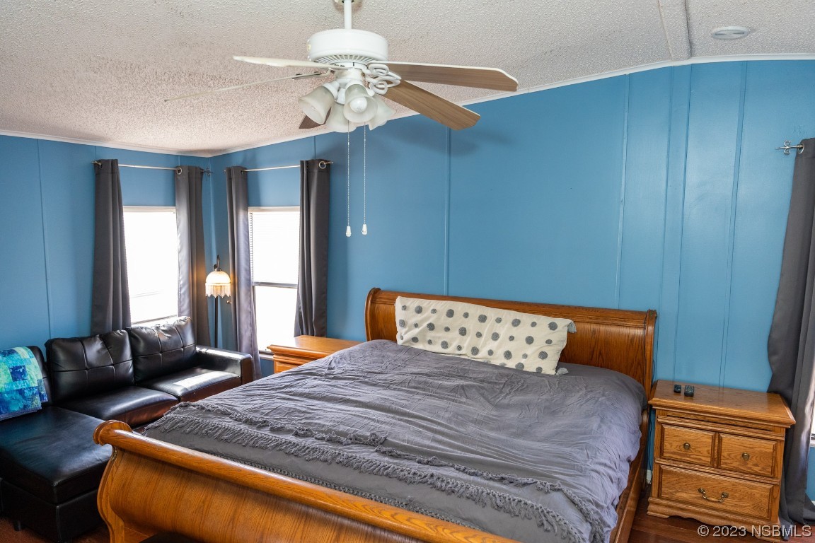 106 Charles Street Edgewater, FL 32141 - Photo 33 of 89 a bedroom with a bed and dresser with wooden floor