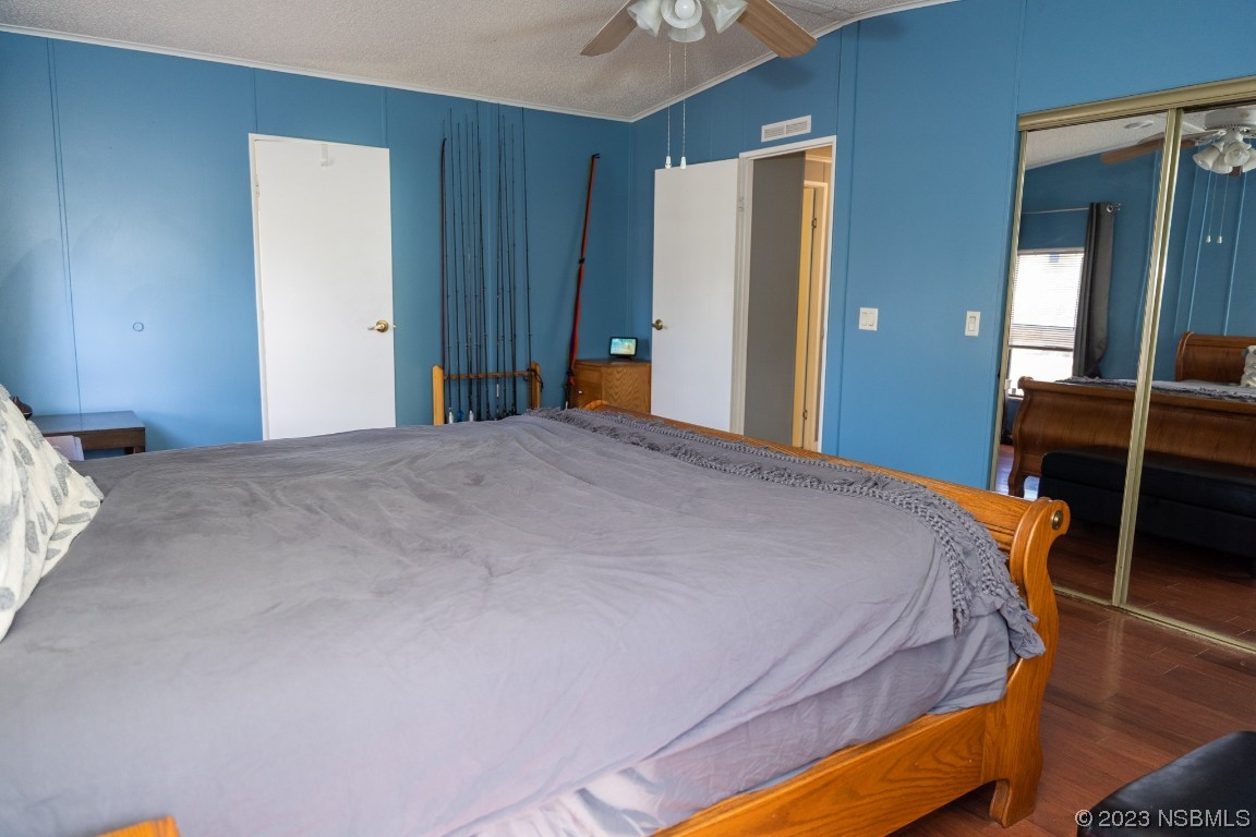 106 Charles Street Edgewater, FL 32141 - Photo 34 of 89 a bedroom with a bed and wooden furniture