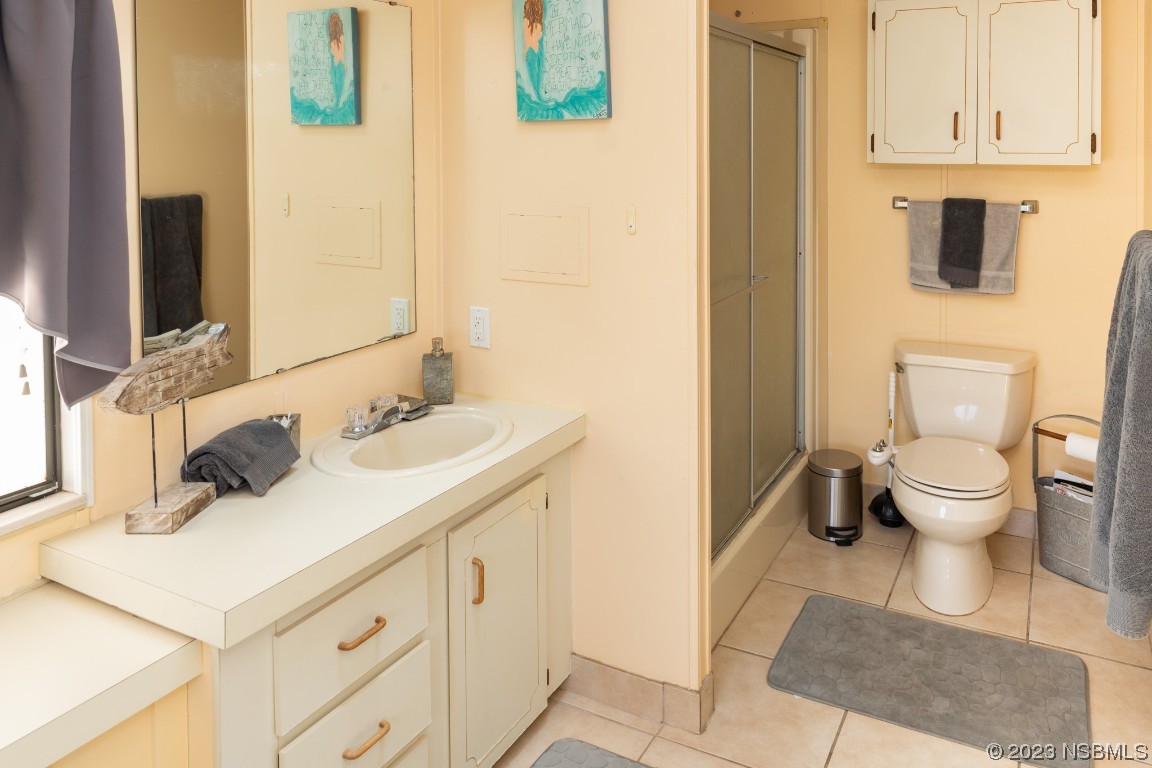 106 Charles Street Edgewater, FL 32141 - Photo 37 of 89 a bathroom with a sink toilet and mirror