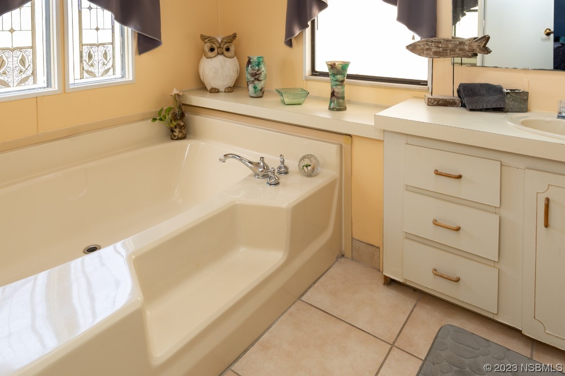 106 Charles Street Edgewater, FL 32141 - Photo 39 of 89 a bathroom with a tub sink and mirror