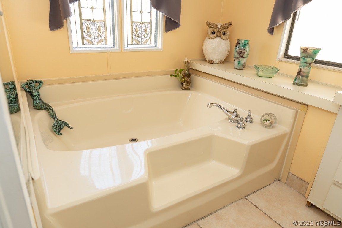 106 Charles Street Edgewater, FL 32141 - Photo 40 of 89 a bathroom with a tub sink and mirror