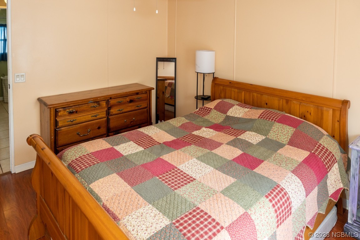 106 Charles Street Edgewater, FL 32141 - Photo 42 of 89 a bedroom with a bed and a lamp