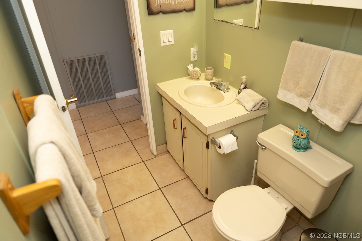 106 Charles Street Edgewater, FL 32141 - Photo 45 of 89 a bathroom with a sink mirror vanity and toilet