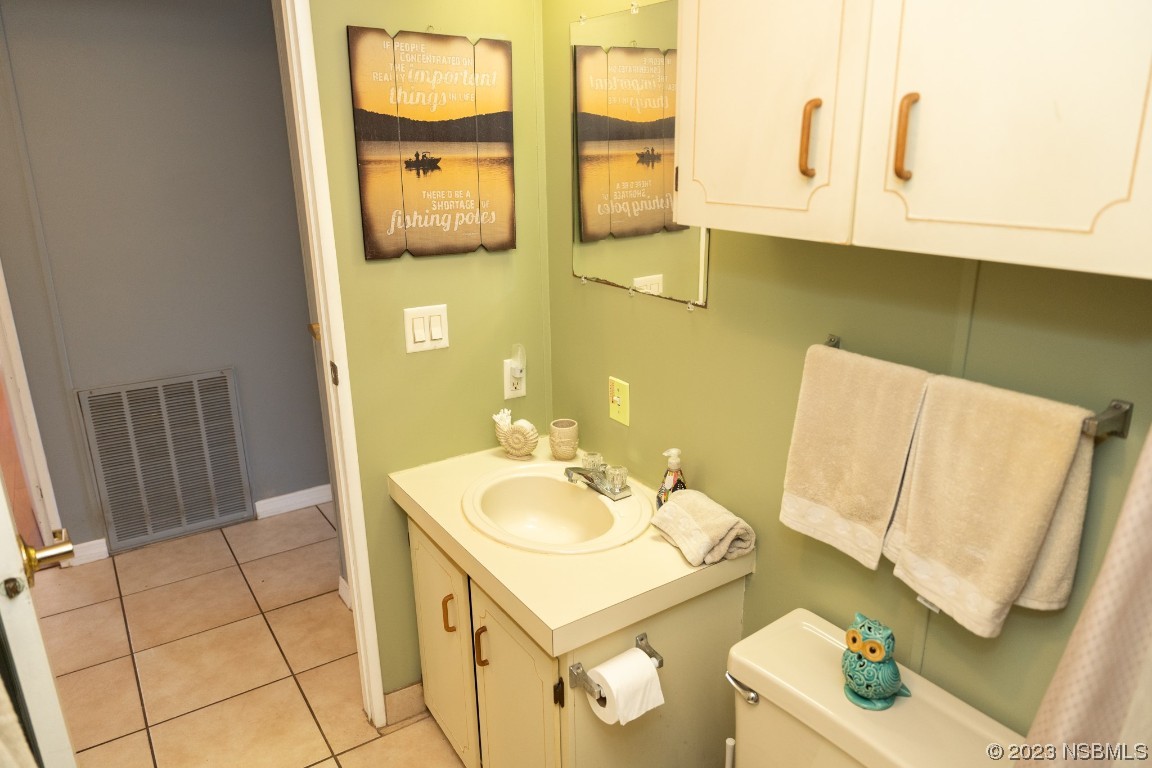 106 Charles Street Edgewater, FL 32141 - Photo 47 of 89 a bathroom with a sink a toilet and mirror