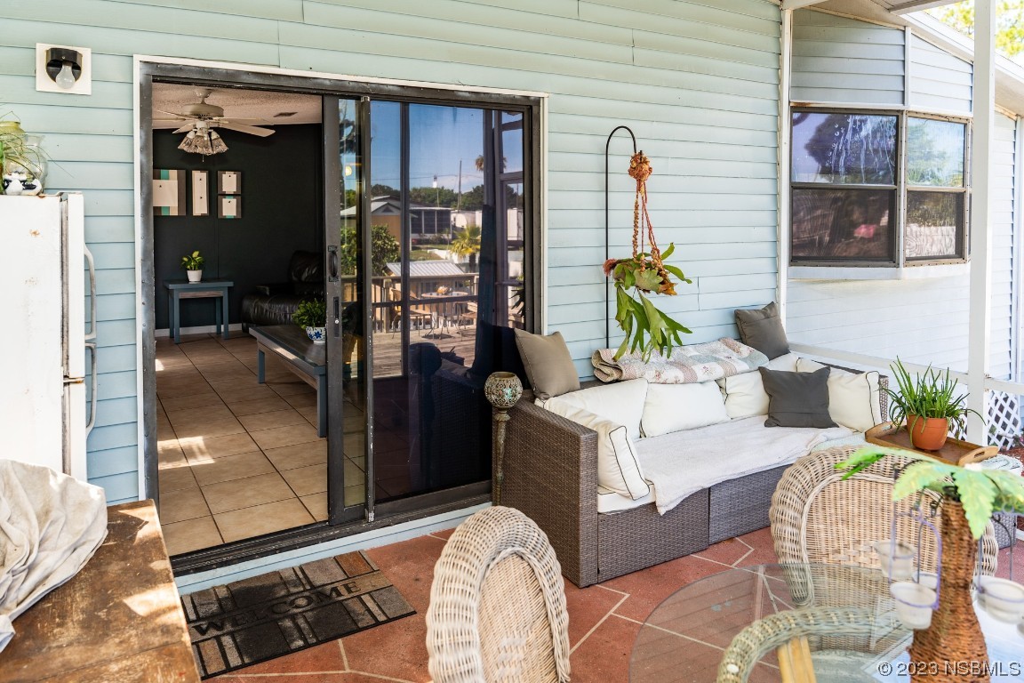 106 Charles Street Edgewater, FL 32141 - Photo 50 of 89 a living room with furniture a floor to ceiling window and wall painting
