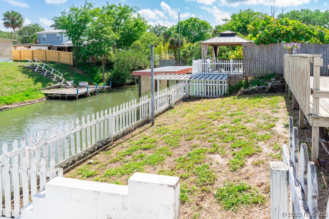 106 Charles Street Edgewater, FL 32141 - Photo 63 of 89 a view of a deck with chairs and wooden fence