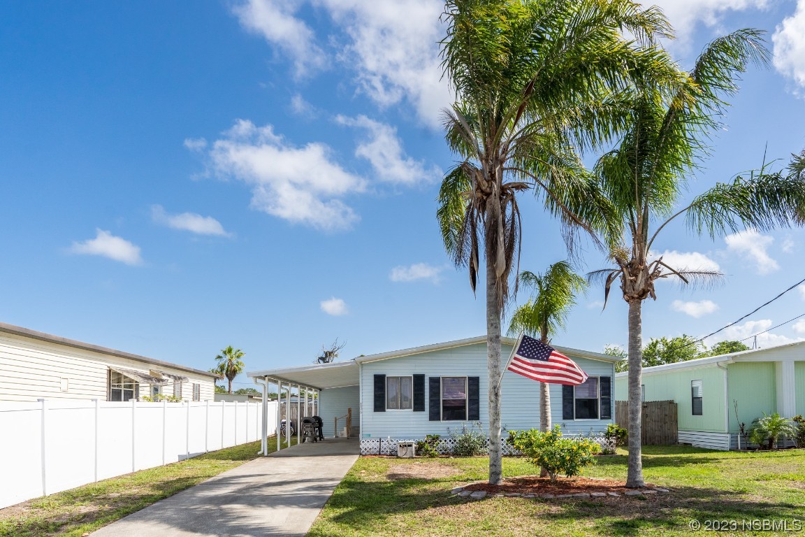 106 Charles Street Edgewater, FL 32141 - Photo 77 of 89 a front view of a house with garden