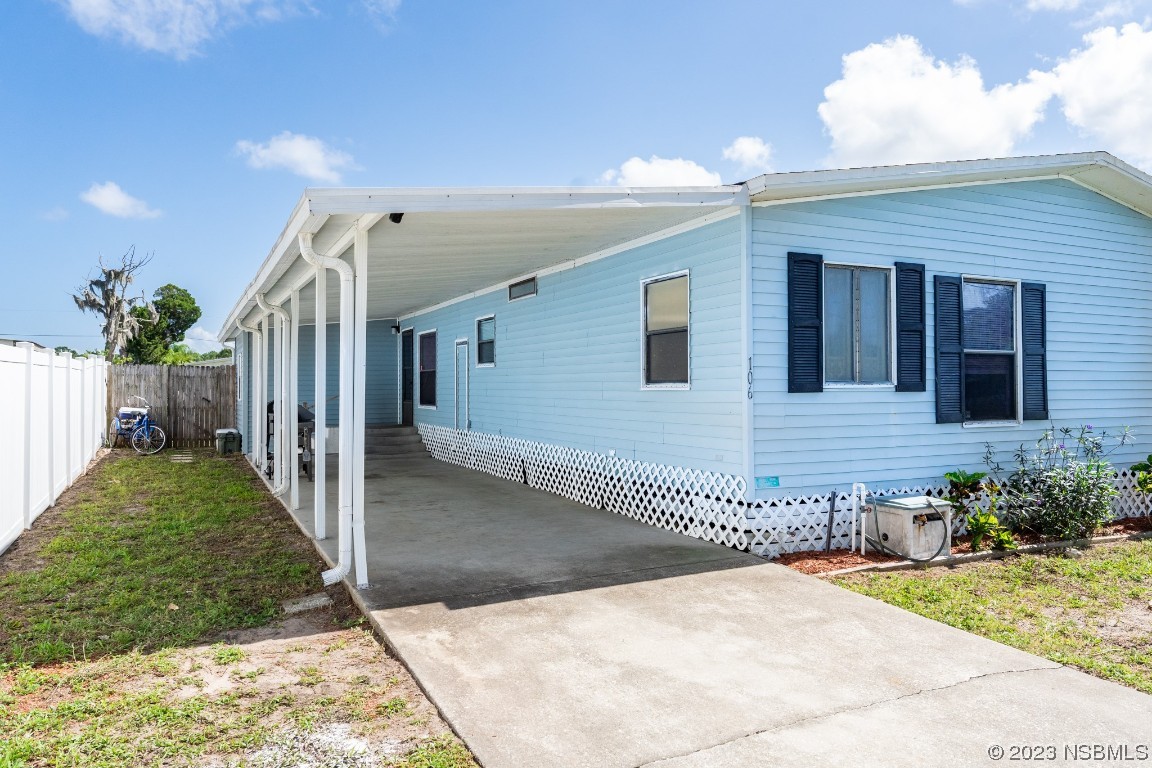 106 Charles Street Edgewater, FL 32141 - Photo 8 of 89 a front view of a house with a yard