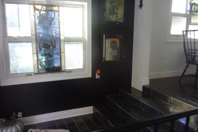 a bedroom with a bed and a mirror