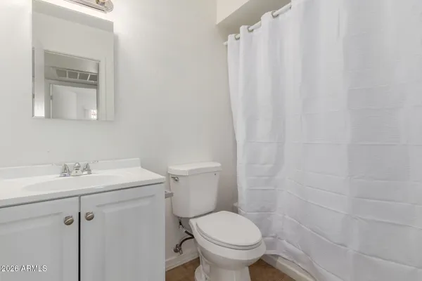 a bathroom with a sink toilet and a mirror