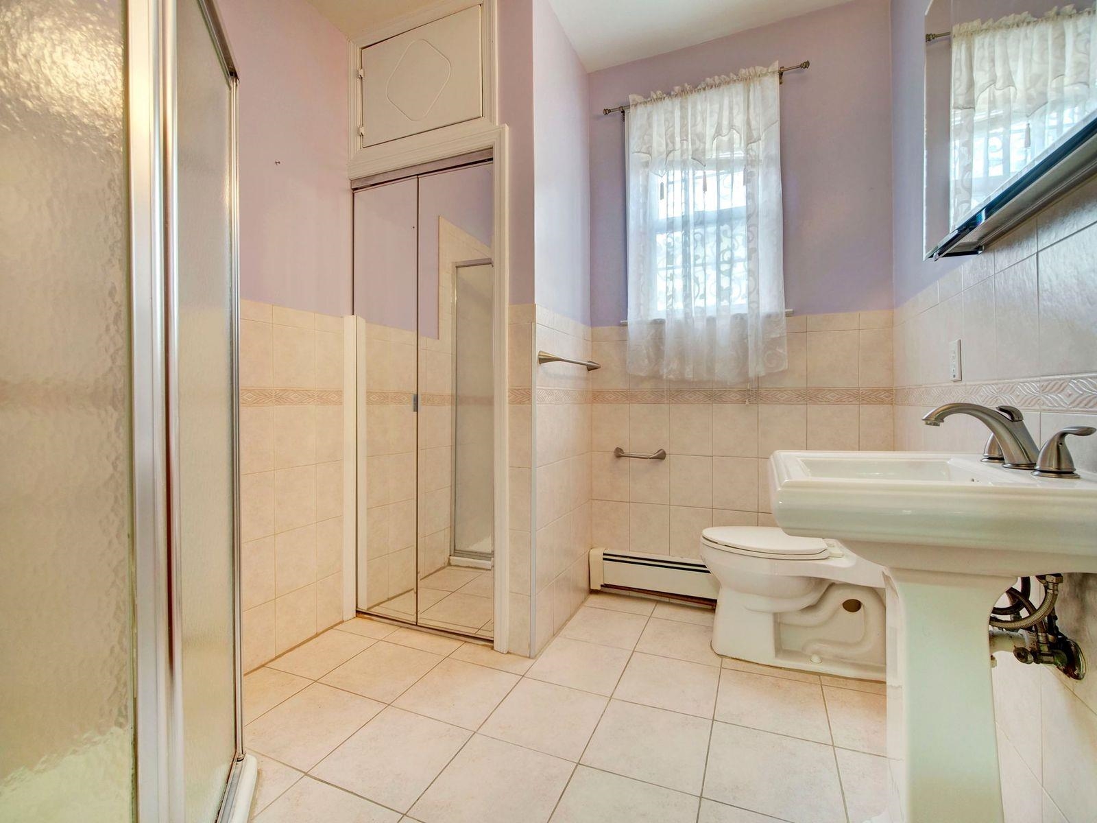 921 Paterson Plank Road, Unit 2 North Bergen, NJ 07047 - Photo 4 of 15 a bathroom with a sink toilet and shower