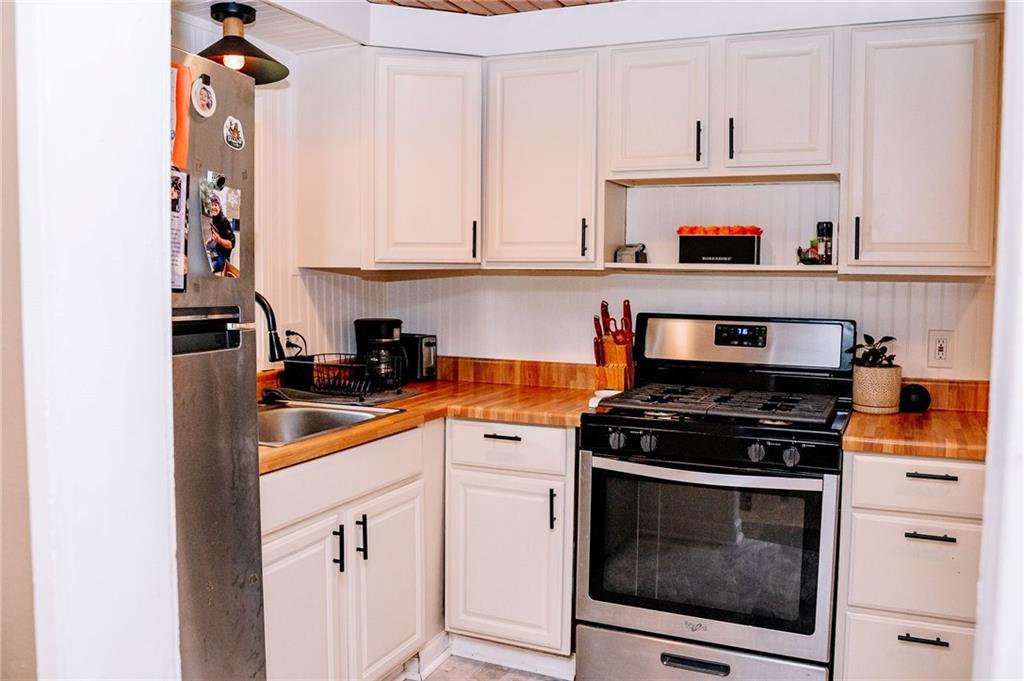 128 Steppland Road Butler, PA 16002 - Photo 5 of 14 a kitchen with white cabinets and appliances