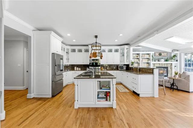 a kitchen with granite countertop a stove and cabinets