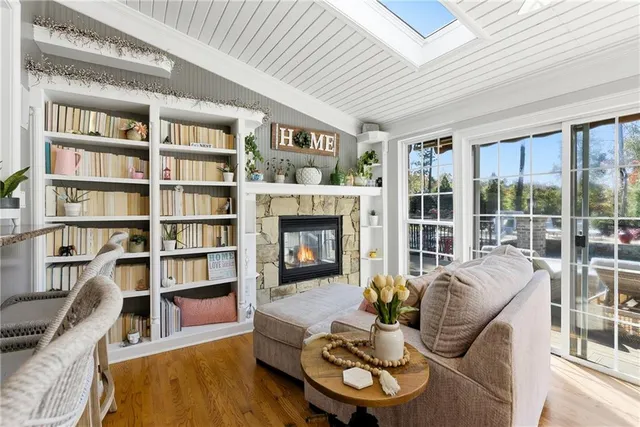 a living room with furniture a flat screen tv and a fireplace