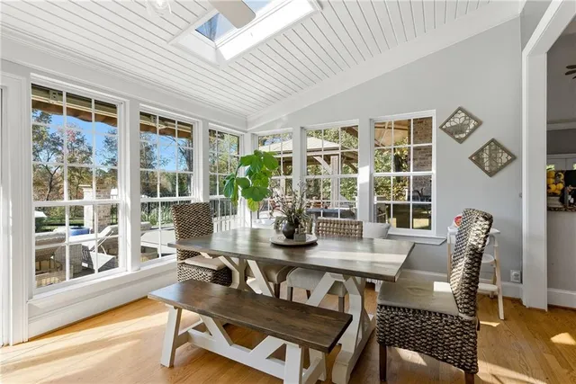a living room with furniture and a view of kitchen
