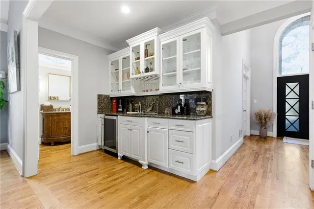a bathroom with a granite countertop sink a mirror and a vanity