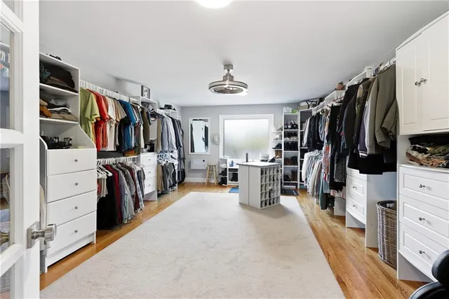 a bathroom with a granite countertop sink vanity mirror and toilet
