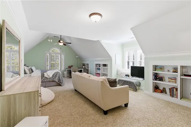 a view of patio with table and chairs under an umbrella with a barbeque