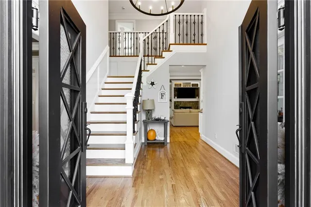 a kitchen with stainless steel appliances granite countertop a stove and a view of living room