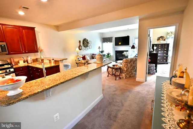 a kitchen with stainless steel appliances granite countertop a refrigerator stove top oven a sink and dishwasher