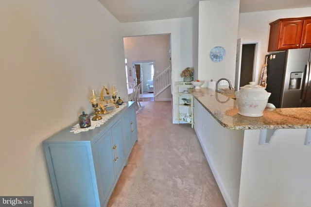 a large kitchen with kitchen island granite countertop wooden cabinets a stove and a sink