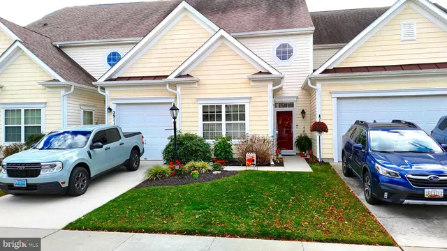 a front view of a house with a garden and plants