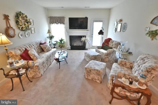 a living room with furniture a couch and paintings on the wall