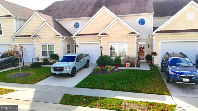 a front view of a house with a garden and plants